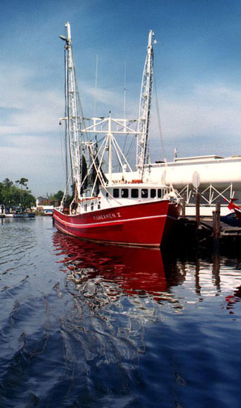 Classic red fishing boat tied up at dock